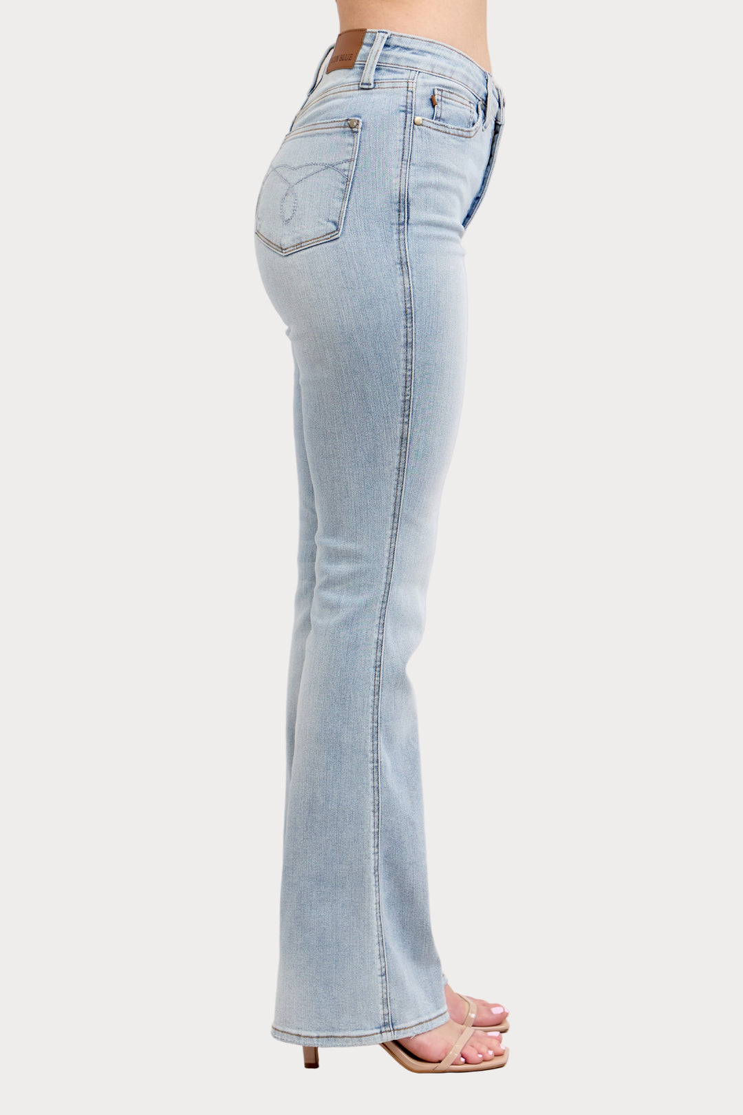 Light blue jeans worn by a person on a white background