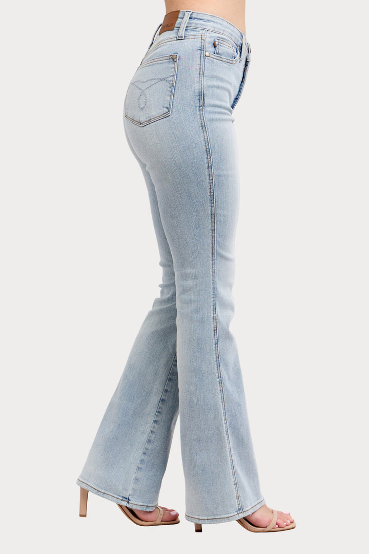 Light blue flared jeans worn by a person on a white background