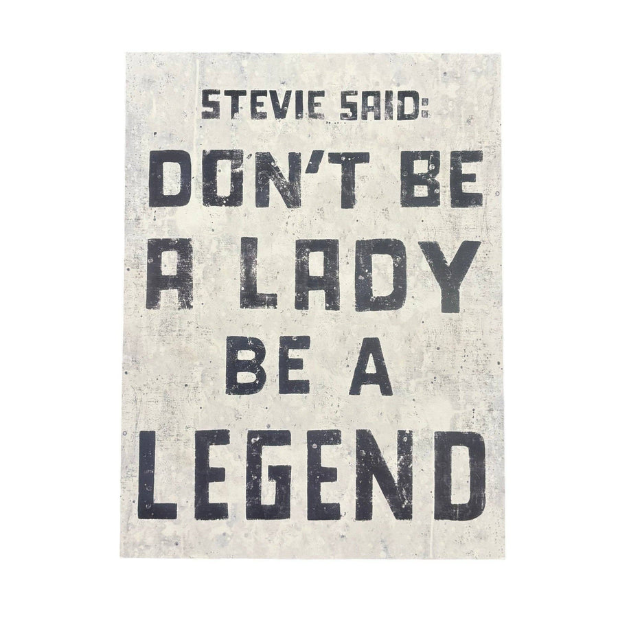 A poster with a black and white color scheme featuring the text 'Stevie Said: Don't Be a Lady Be a Legend' in stylized font on a distressed background.