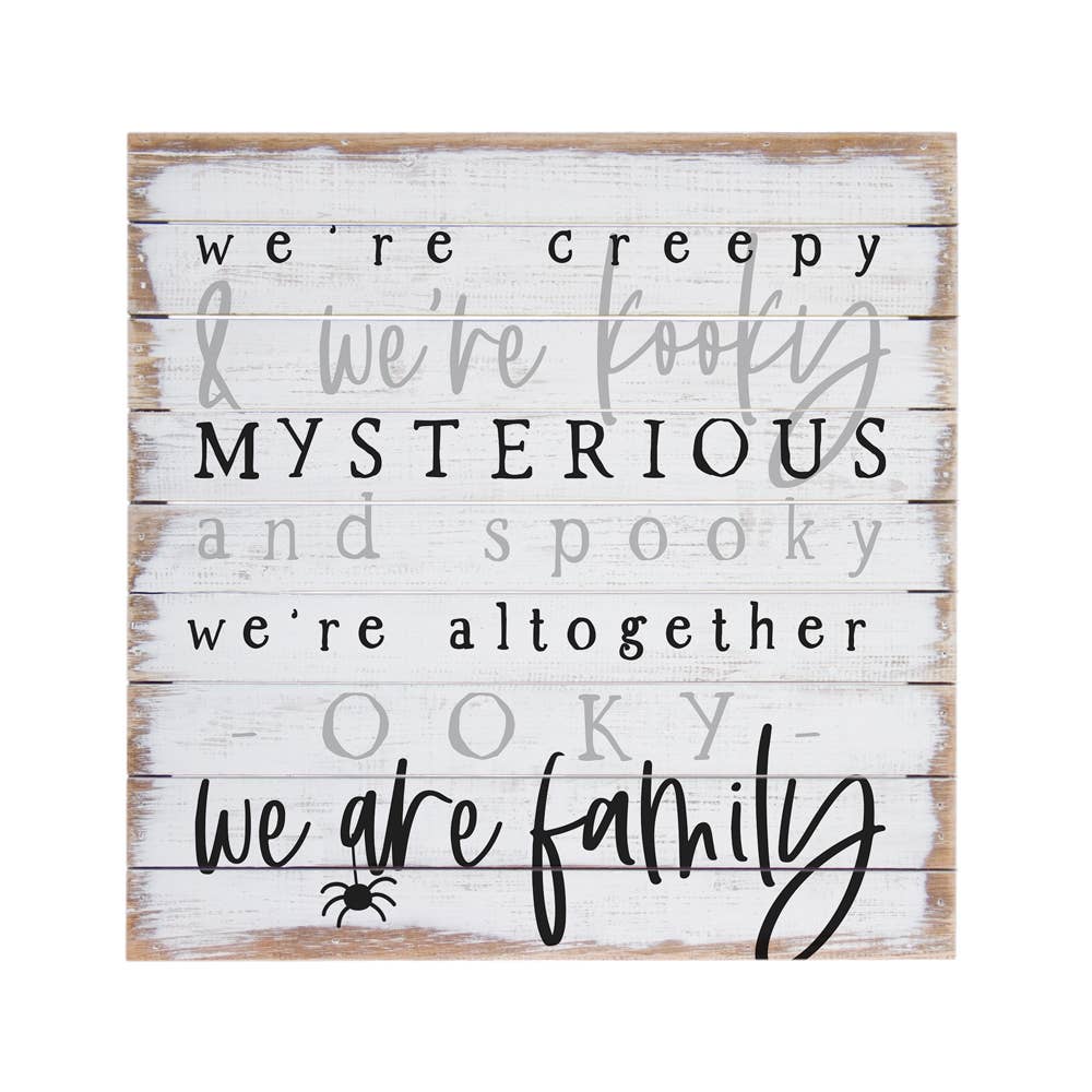 Wooden sign with Halloween-themed Addams family theme song lyric text on a white background