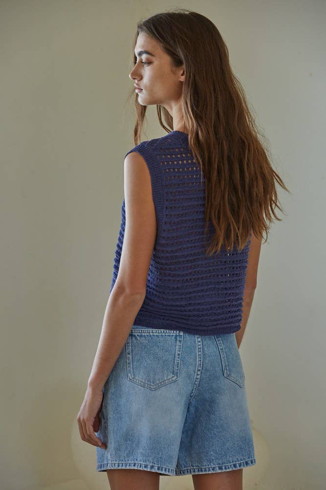 Midnight navy crochet knit sweater vest with round neck, styled with denim for a casual boho look.