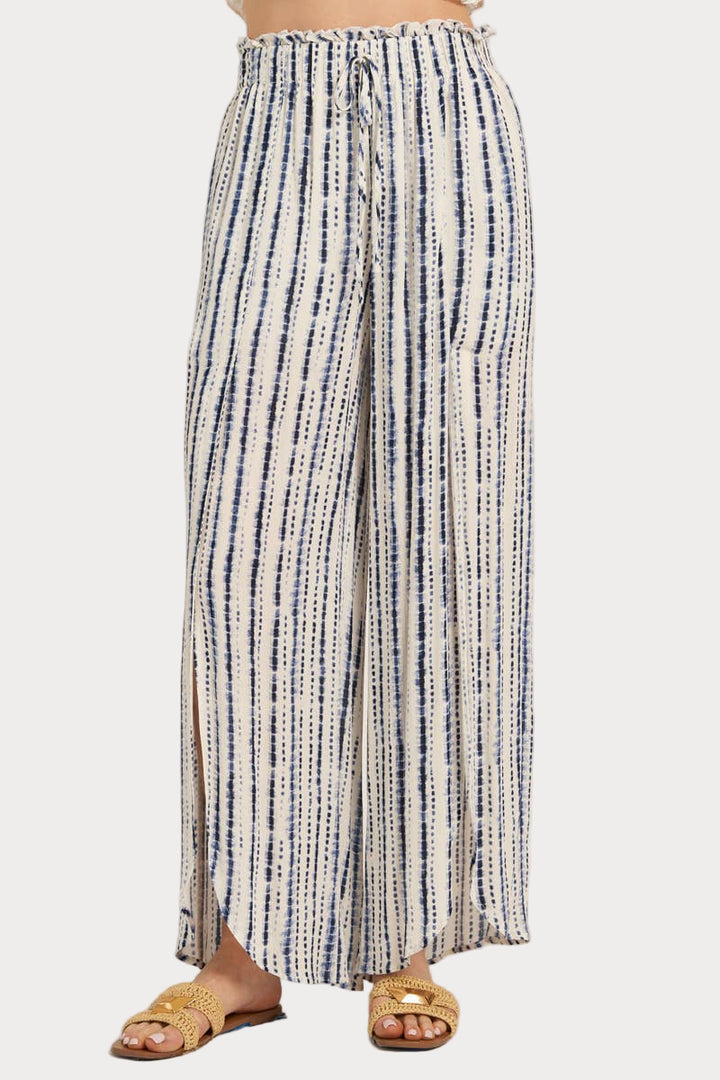Striped pants worn by a person on a white background