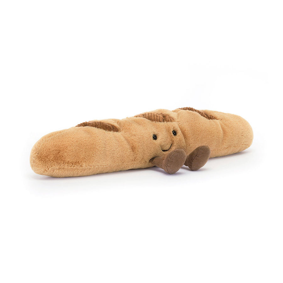 Amuseables Baguette plush with golden brown fur, smiling face, and little corduroy feet.