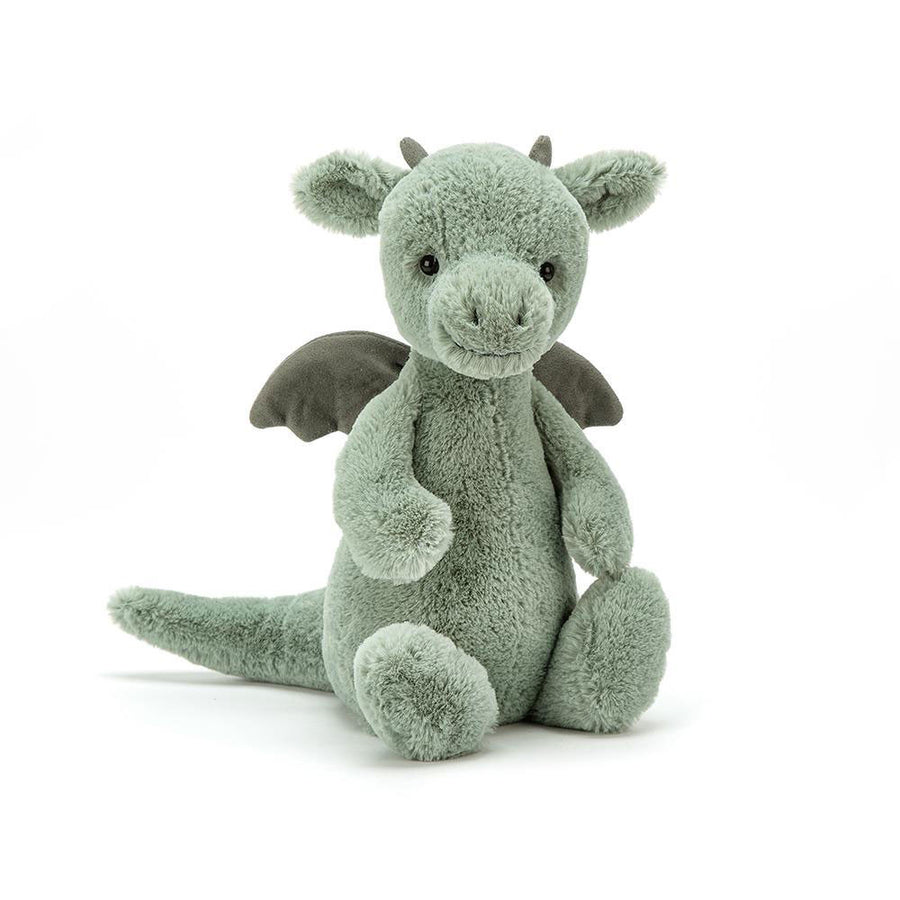 Bashful Dragon plush with soft green fur, wings, and a gentle smile sitting upright.