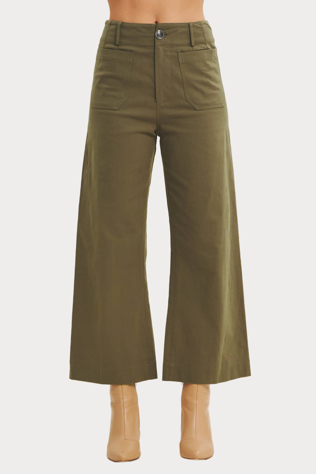 Green wide-leg pants on a beige background