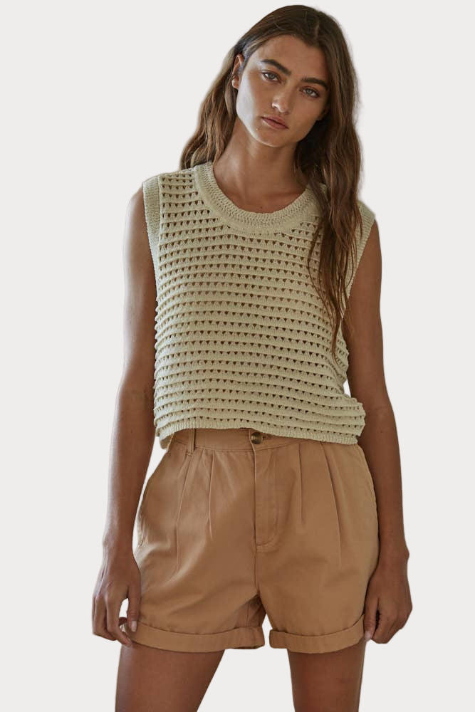 Natural crochet knit sleeveless vest with round neck, paired with shorts for a relaxed summer outfit.