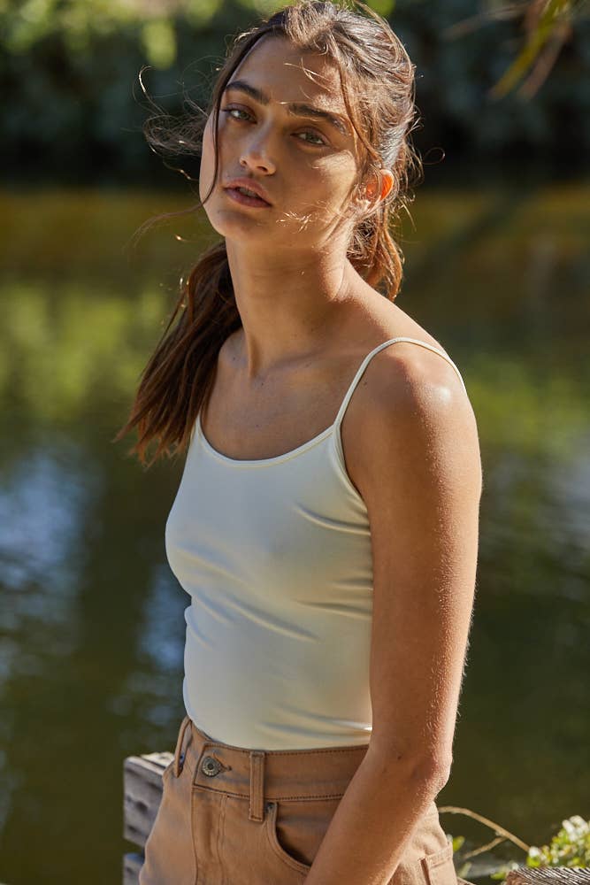 Seamless ivory full-length cami with thin straps, styled with khaki denim for a sleek everyday look.