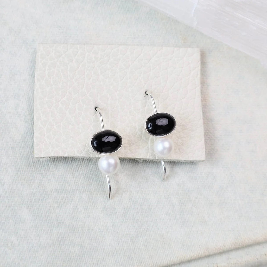 Handcrafted sterling silver earrings with black onyx and freshwater pearl drops, designed by Jeff Gray Jewelry in Bennington, Vermont.