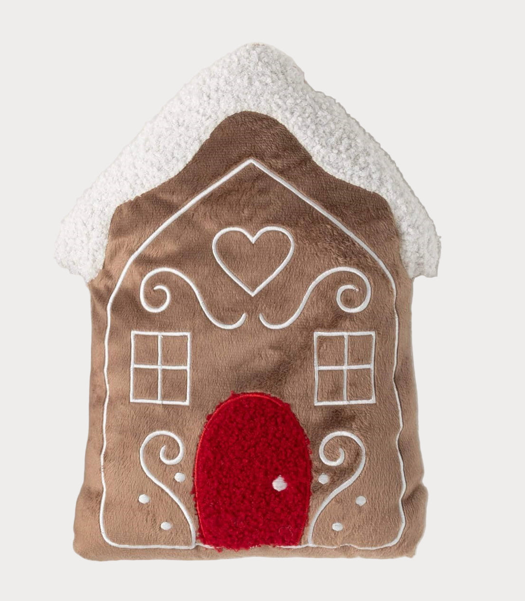 Plush gingerbread house pillow with red door and snowy white roof