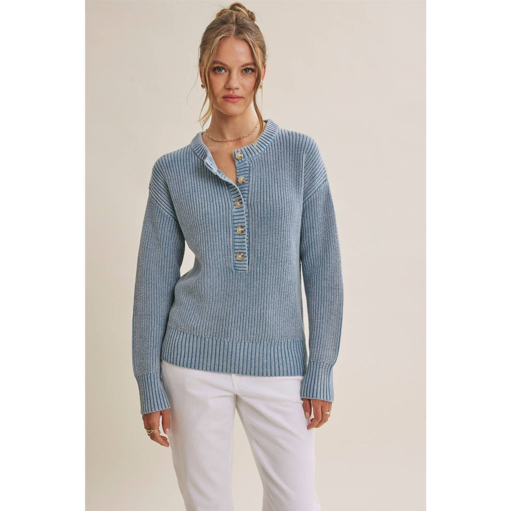 Woman wearing The Sutton mineral-wash blue Henley sweater with white pants
