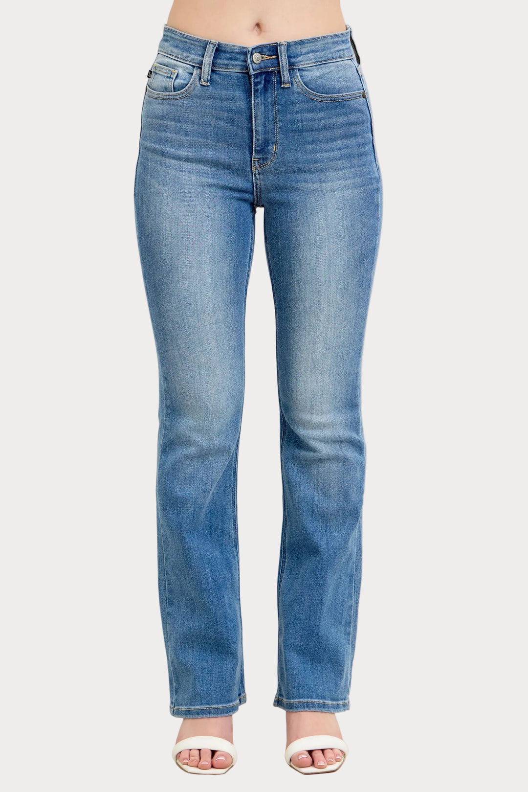 Model wearing high waist contrast wash bootcut jeans with classic stretch denim fit