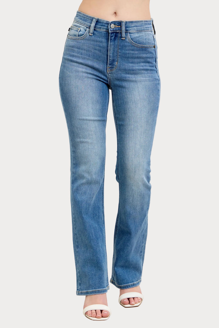 Model wearing high waist contrast wash bootcut jeans with classic stretch denim fit