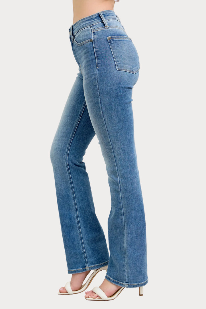 Model wearing high waist contrast wash bootcut jeans with classic stretch denim fit
