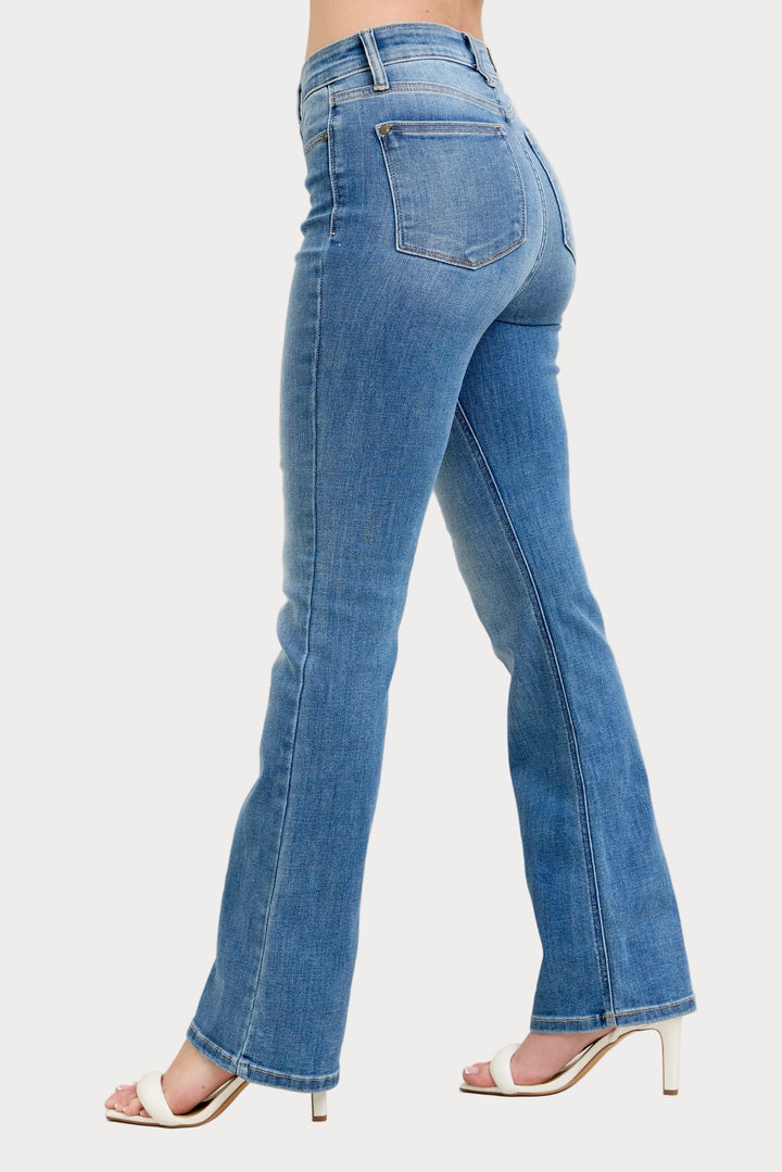 Model wearing high waist contrast wash bootcut jeans with classic stretch denim fit