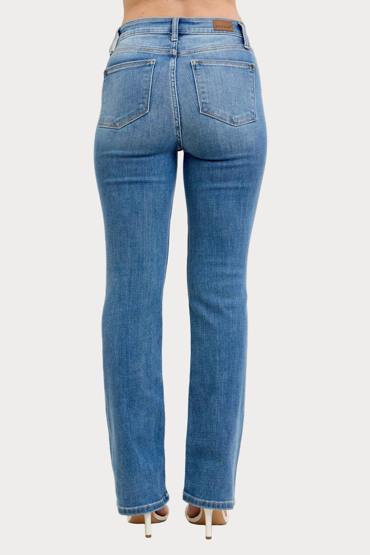 Model wearing high waist contrast wash bootcut jeans with classic stretch denim fit