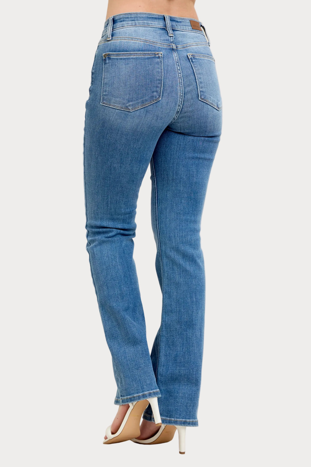 Model wearing high waist contrast wash bootcut jeans with classic stretch denim fit