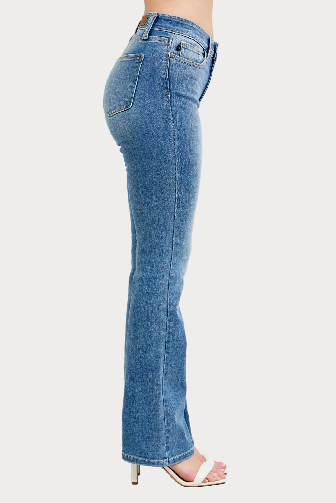 Model wearing high waist contrast wash bootcut jeans with classic stretch denim fit