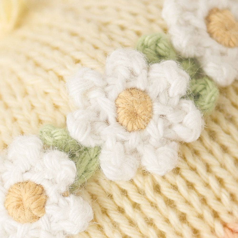 Close-up of knitted flowers on a textured fabric background