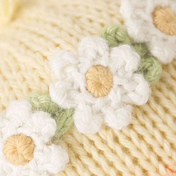 Close-up of knitted flowers on a textured fabric background