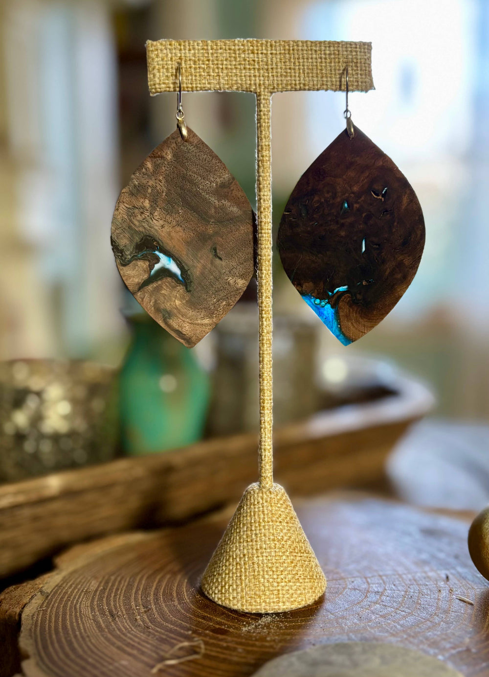 Handcrafted midnight walnut wood and blue resin statement earrings with natural grain patterns and hypoallergenic stainless-steel hardware.