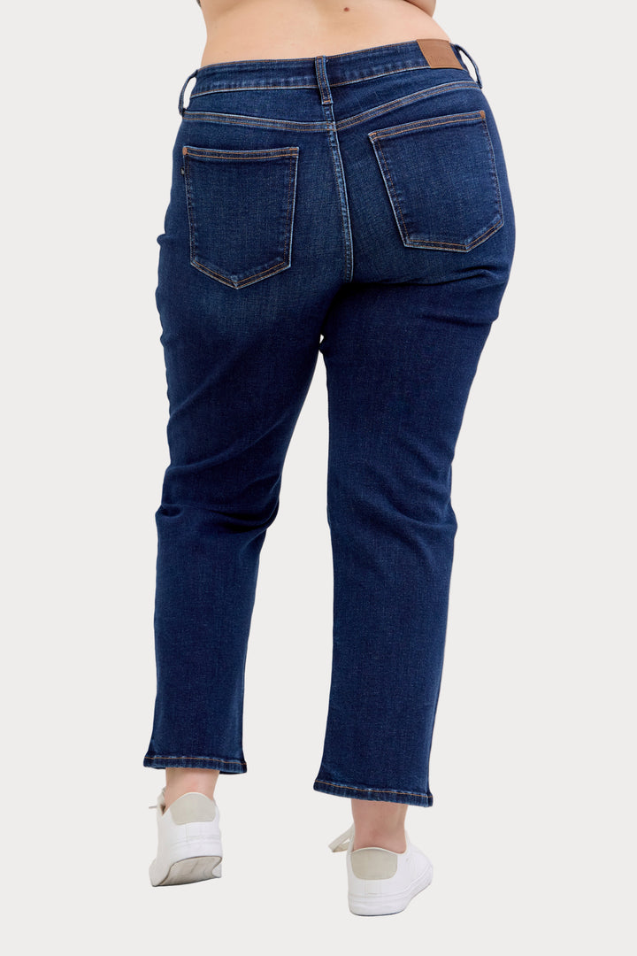 Model wearing Judy Blue mid-rise dark wash straight jeans with a short 30-inch inseam rear view