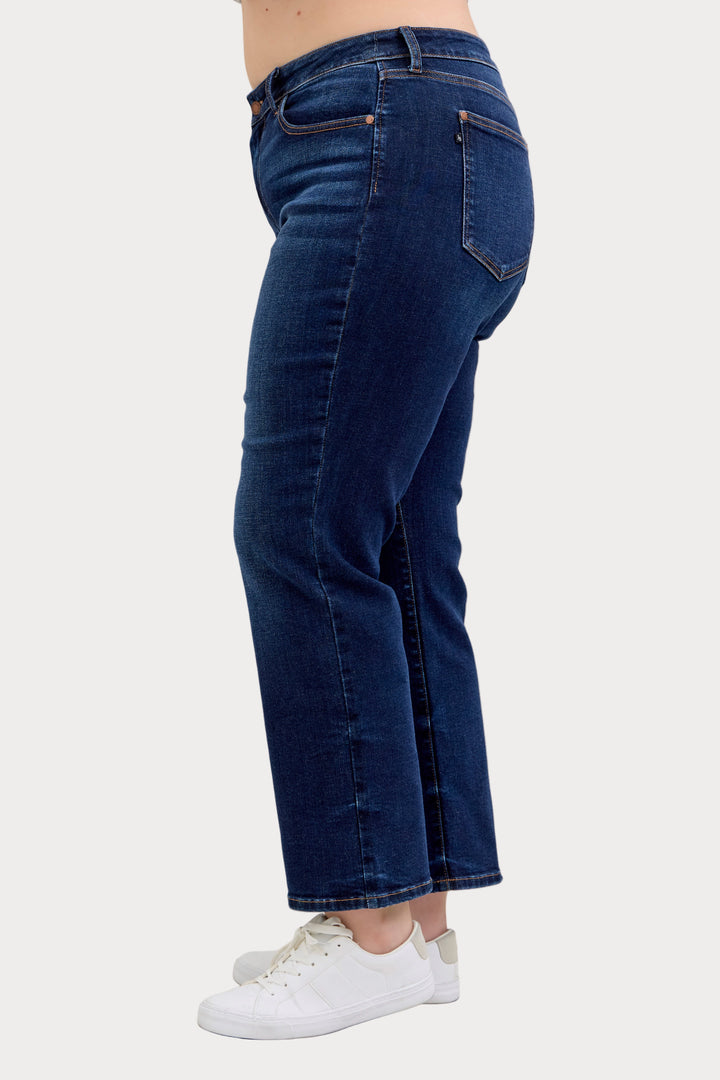 Model wearing Judy Blue mid-rise dark wash straight jeans with a short 30-inch inseam left facing side view