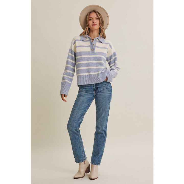 Woman wearing The Marlowe ice blue and ivory striped brushed Henley sweater with blue jeans