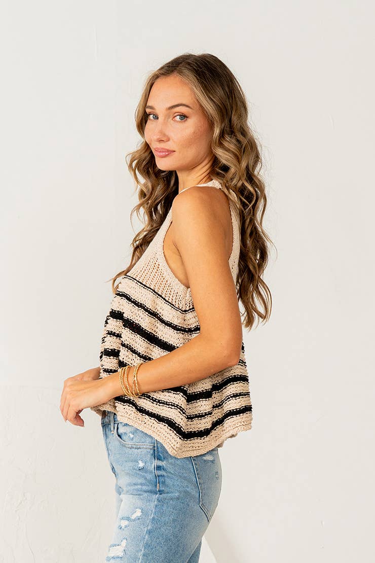 Woman wearing striped crochet knit sleeveless tank top with denim shorts