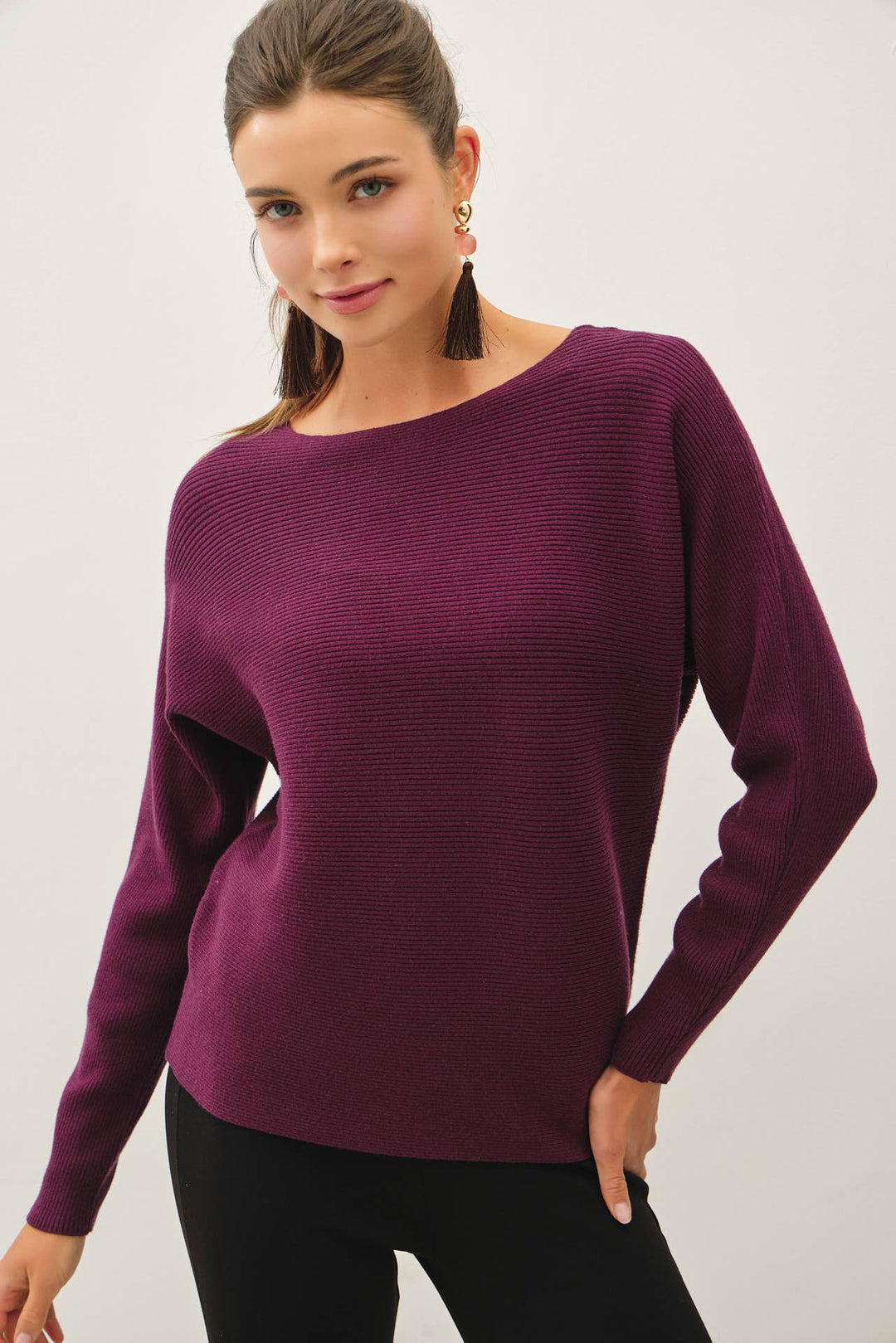 Be Cool The Shelby Sweater in deep plum purple featuring a ribbed knit, boat neckline, long dolman sleeves, and relaxed hip-length fit.