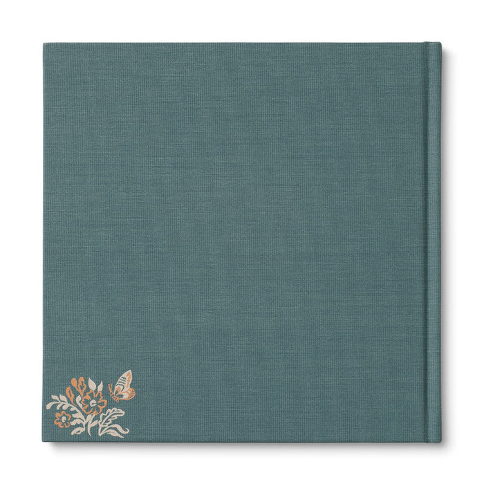 Teal notebook with floral design on a white background
