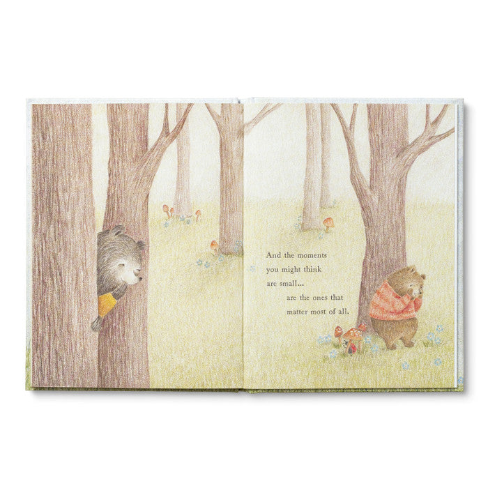 Illustrated book open to a page with two bears in a forest setting.