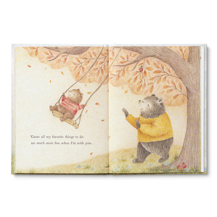 Illustrated book open to two pages with bear characters swinging in a tree