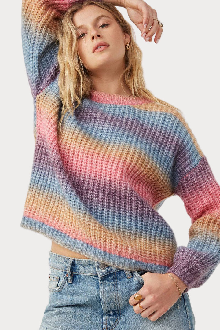 Women wearing ombre striped chunky knit sweater in soft pink, blue, and golden tones—cozy and colorful fall outfit, sizes S–3X.