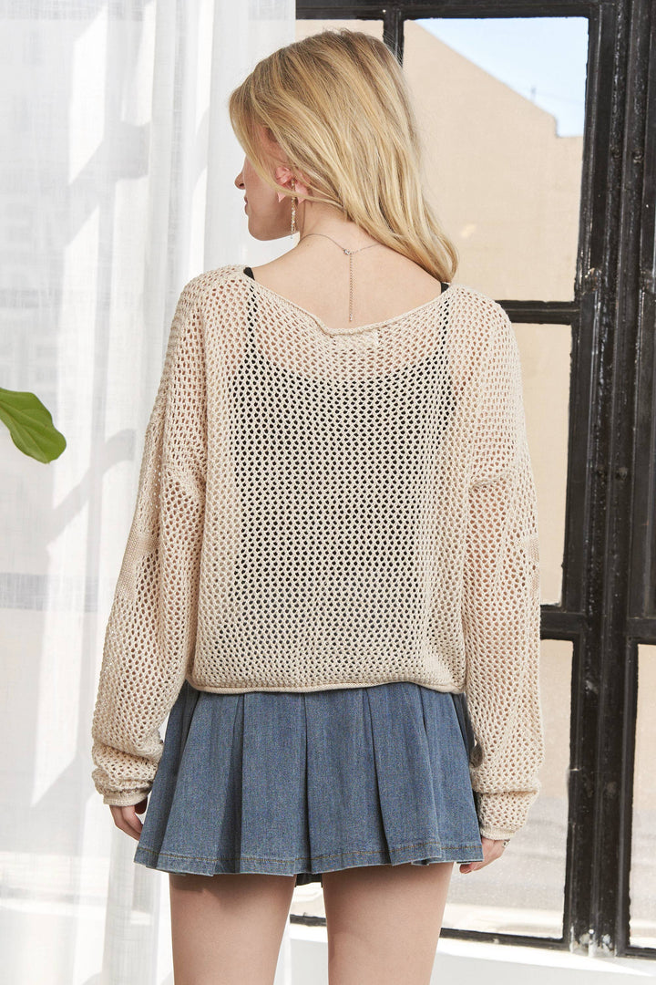 Plus size beige knit sweater with star design and oversized fit.