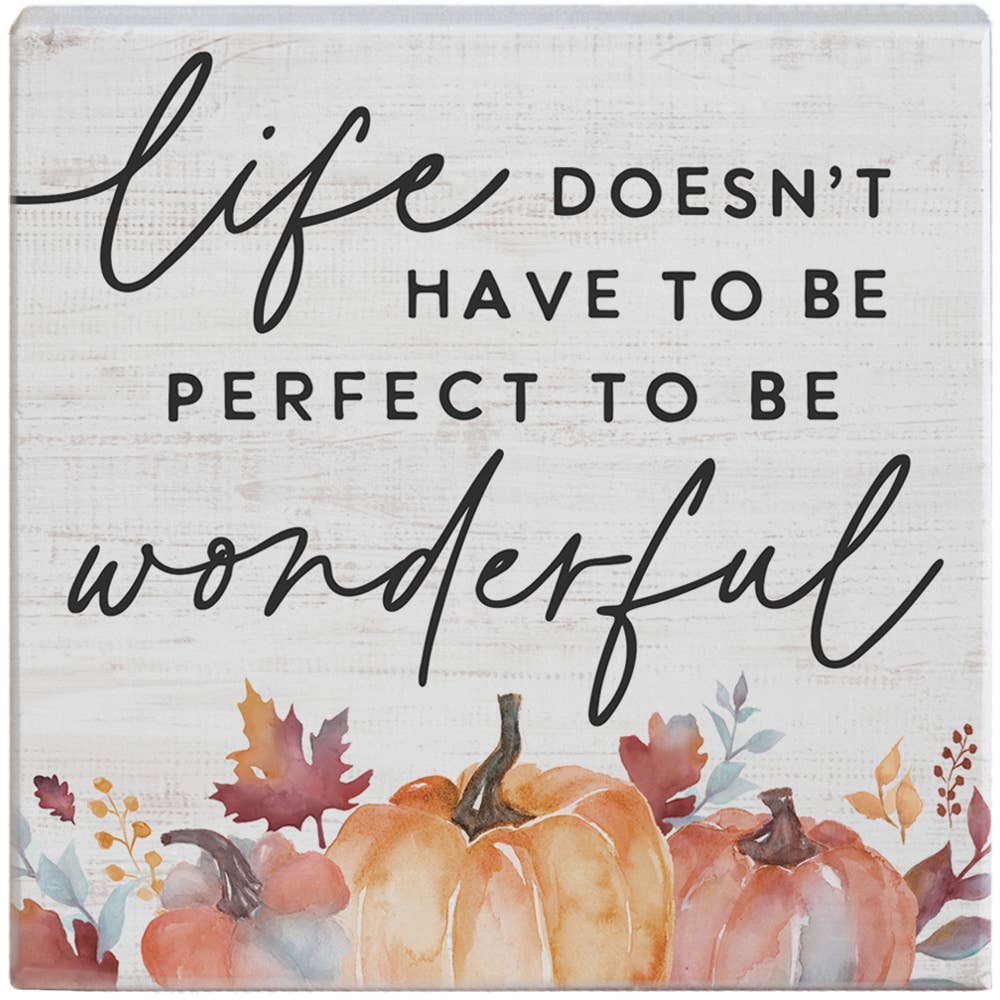 Decorative sign with pumpkins and autumn leaves featuring the quote 'Life doesn't have to be perfect to be wonderful'.