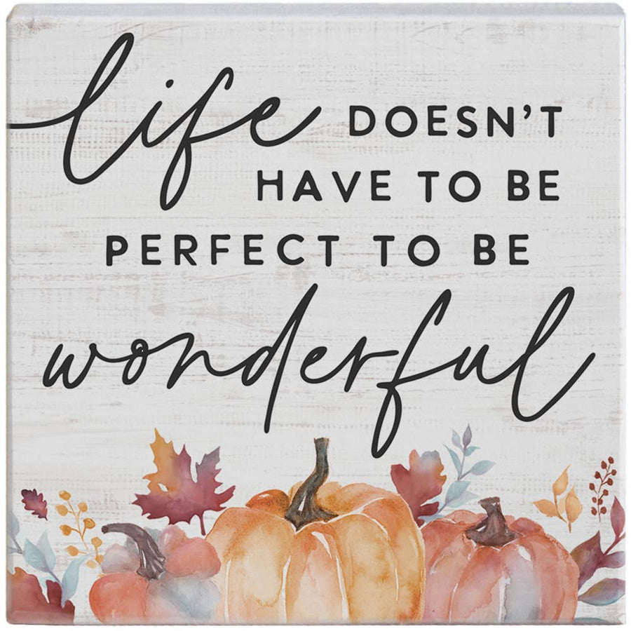 Decorative sign with pumpkins and autumn leaves featuring the quote 'Life doesn't have to be perfect to be wonderful'.