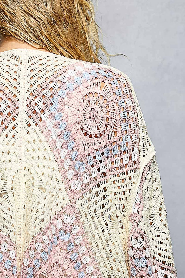 Close-up of a Crochet granny square cardigan with open front and relaxed fit