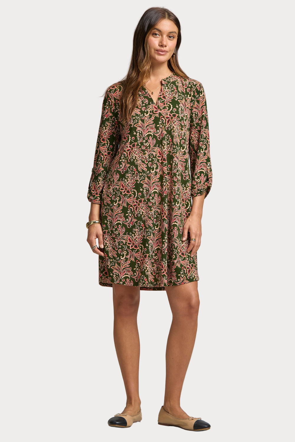 Woman wearing a floral dress on a plain background