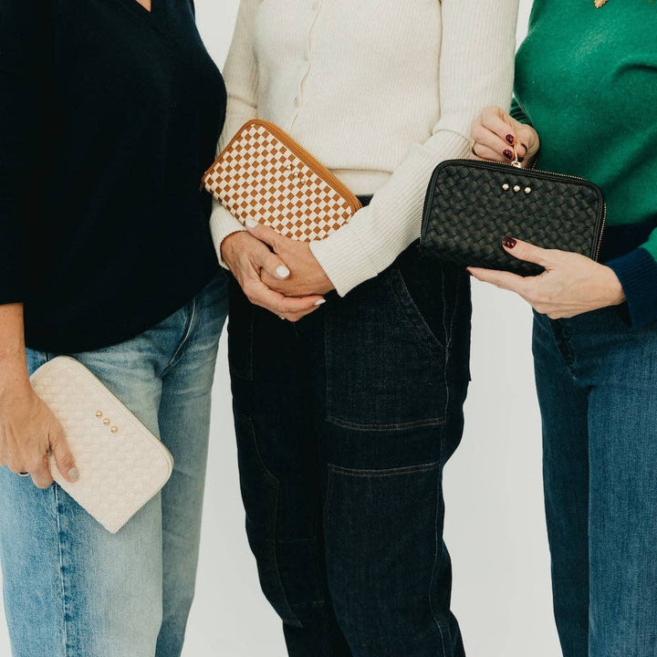 Three people wallets handbags against a plain background