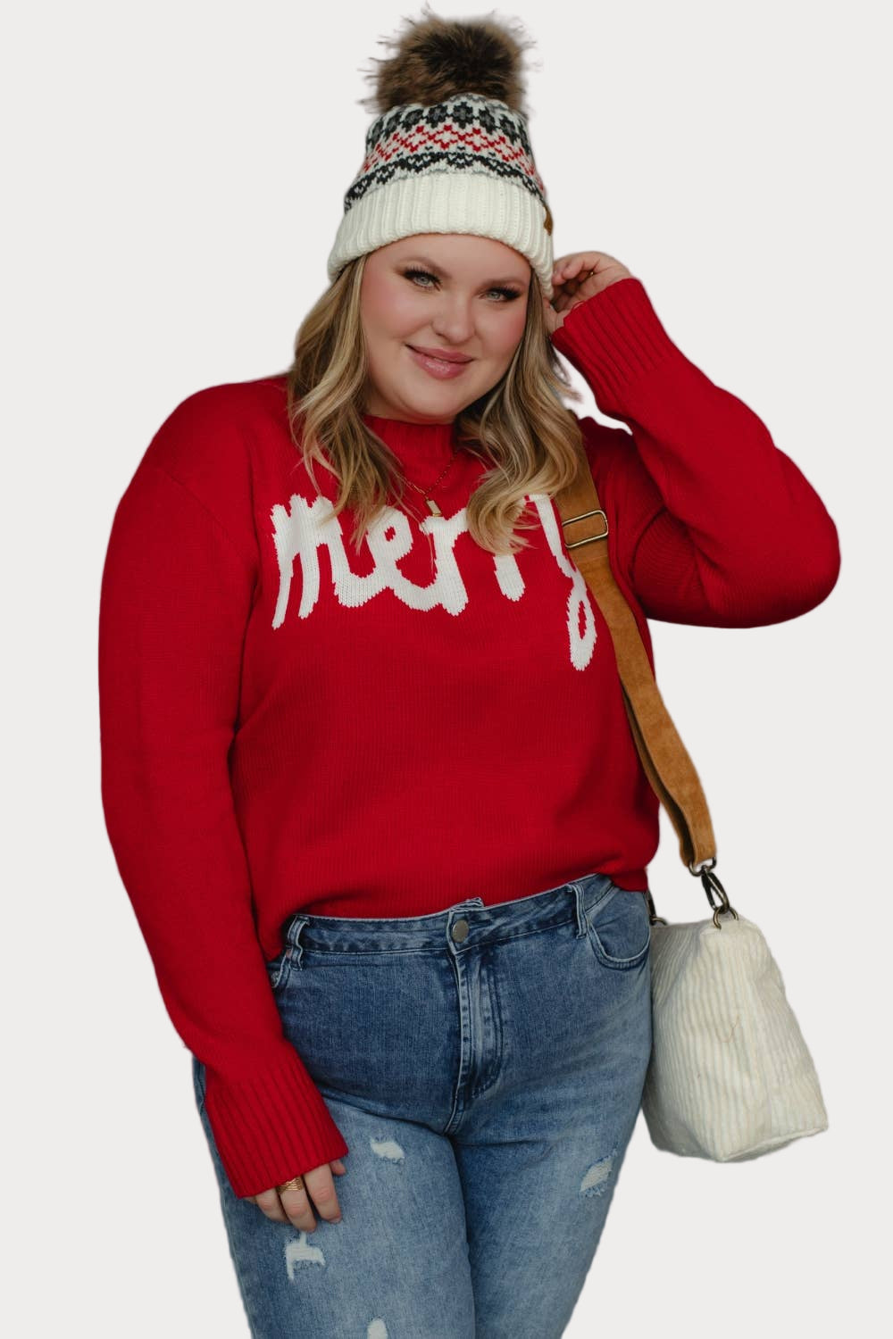 Plus size model wearing a red sweater with 'merry' text against a neutral background