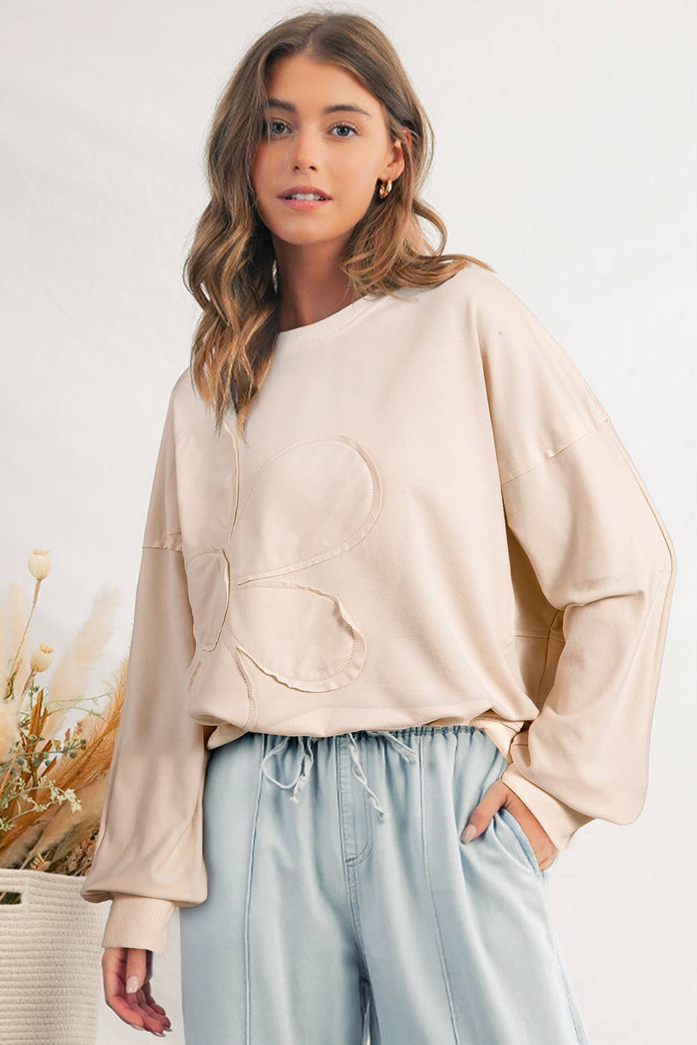 Women's cream oversized floral patch sweatshirt with raw-edge flower detail