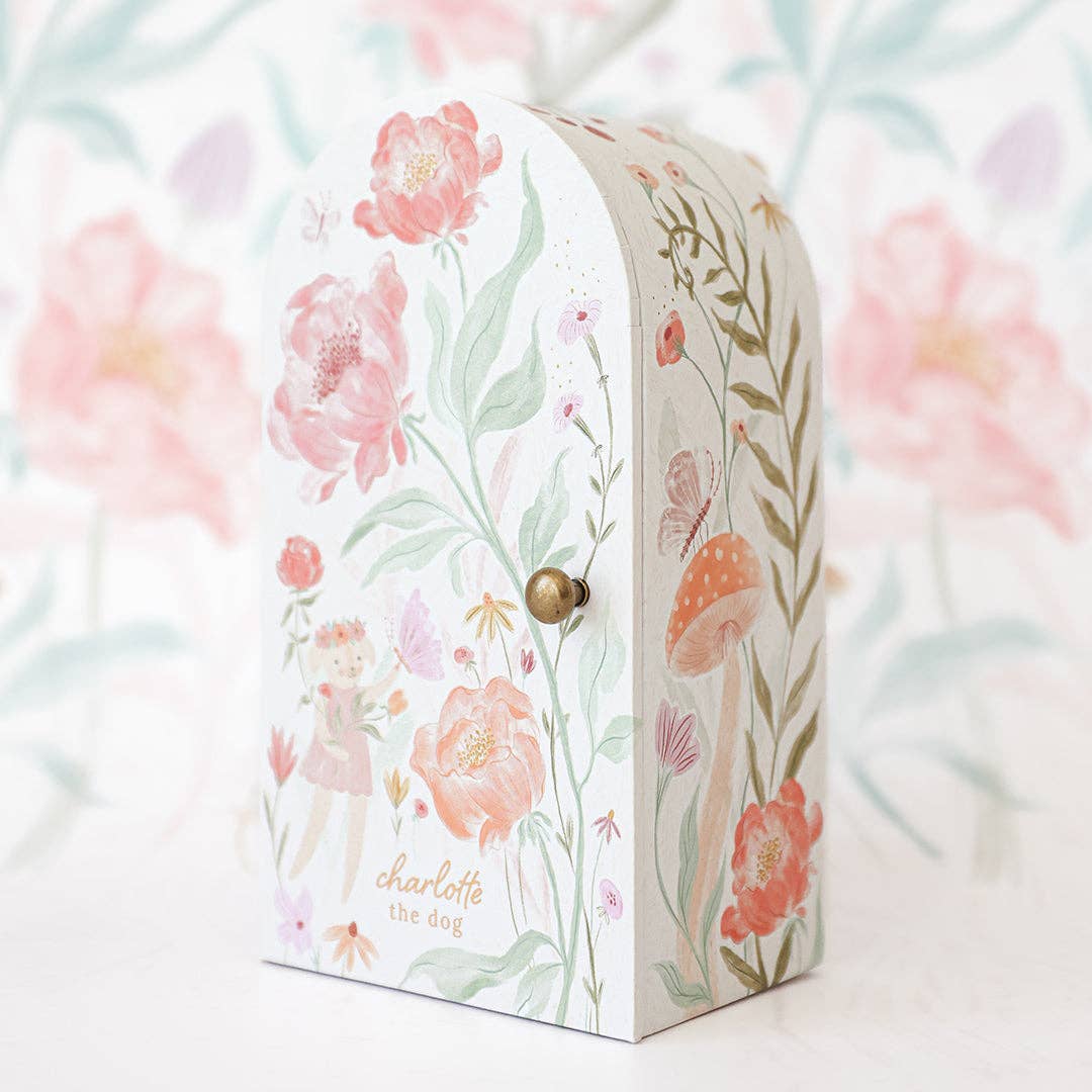 Floral-patterned box with a gold knob on a floral background