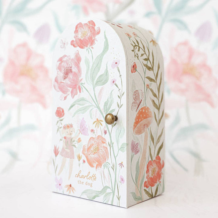 Floral-patterned box with a gold knob on a floral background