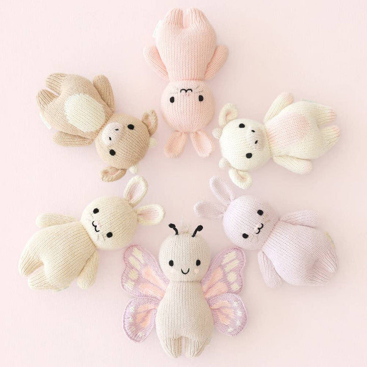 Set of soft plush toy animals on a pink background