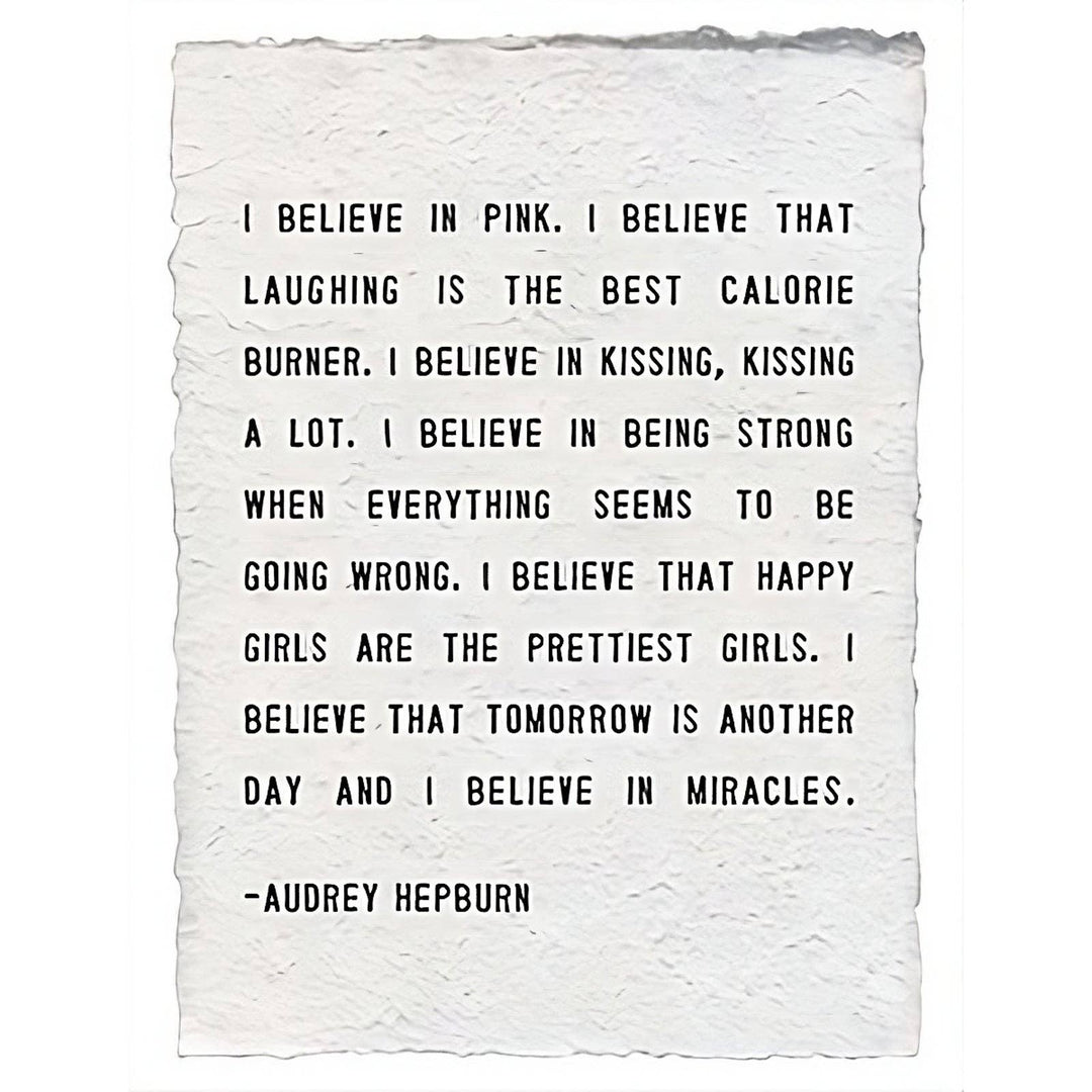A handmade paper print featuring the quote 'I Believe In Pink' by Audrey Hepburn, shown on a white background.