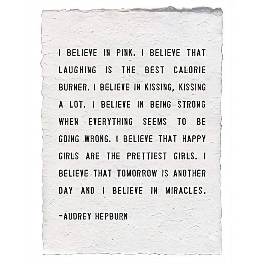 A handmade paper print featuring the quote 'I Believe In Pink' by Audrey Hepburn, shown on a white background.