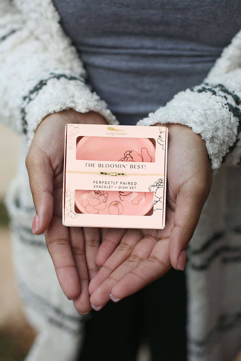 person holding The Bloomin' Best bracelet and floral trinket dish gift set with pink and gold accents
