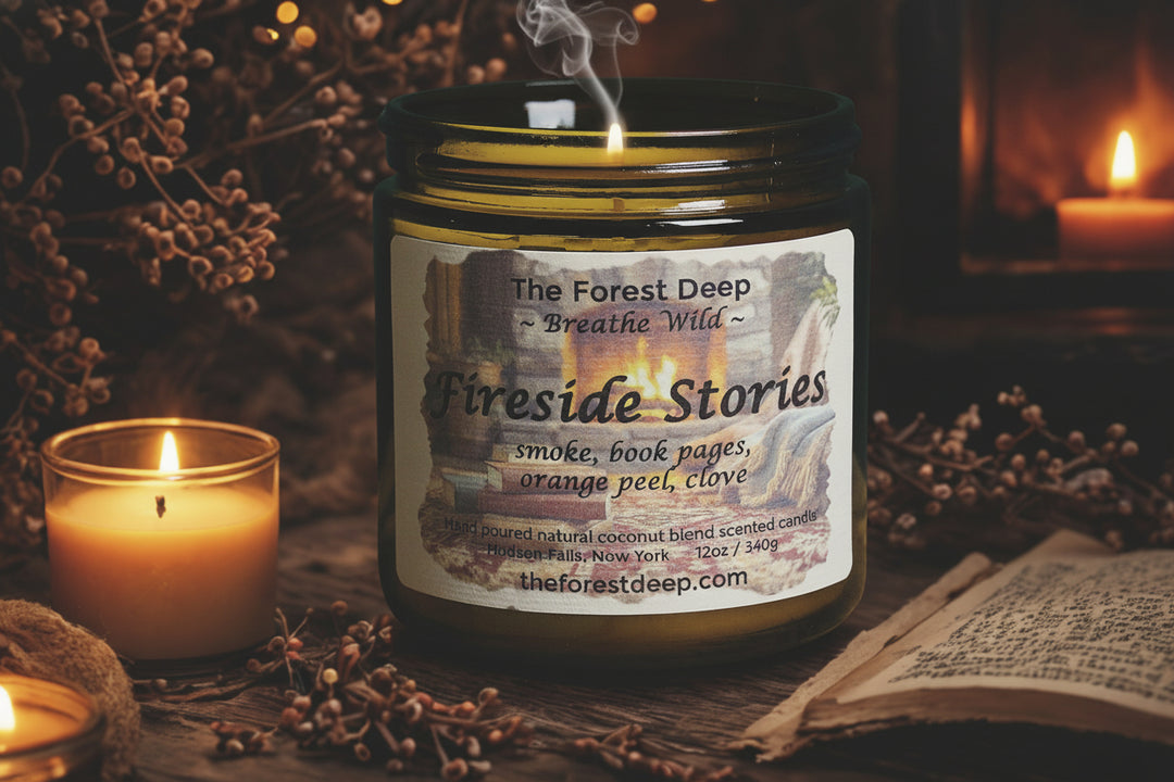 Candle jar labeled 'Fireside Stories' with a lit candle and book in a cozy setting.