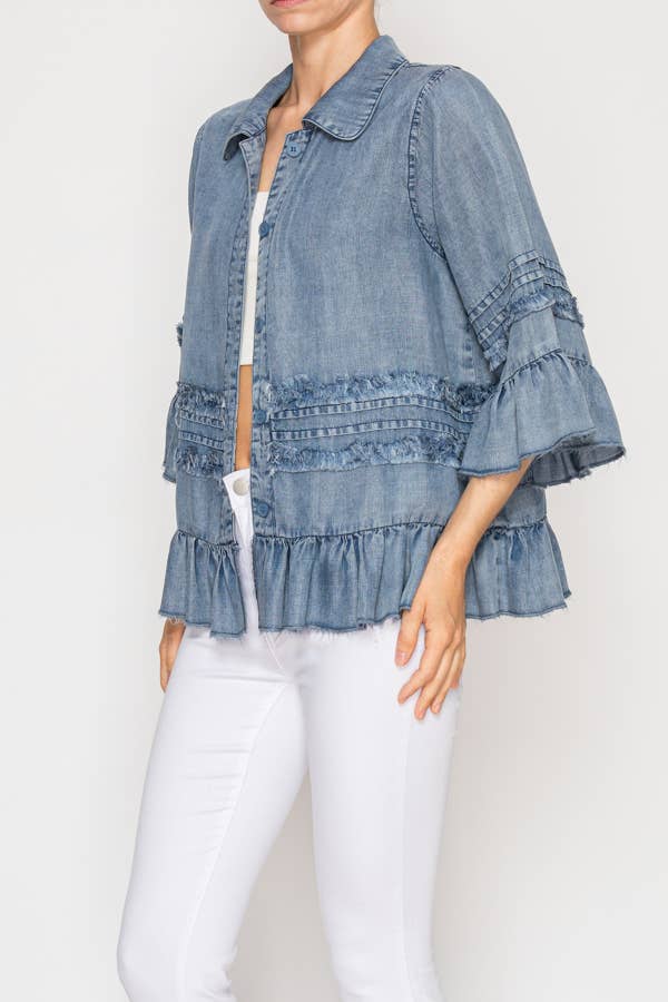 Denim top with ruffled sleeves worn by a person on a white background