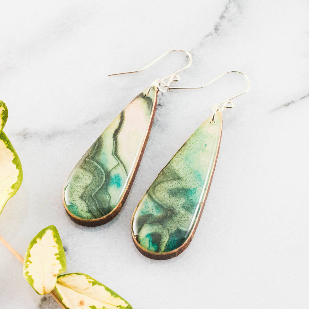 Teardrop green geode inspired wooden earrings with swirling jade turquoise and moss green design